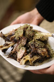Close-up of tender slow-cooked lamb with herbs on a plate, perfect for gourmet meals.