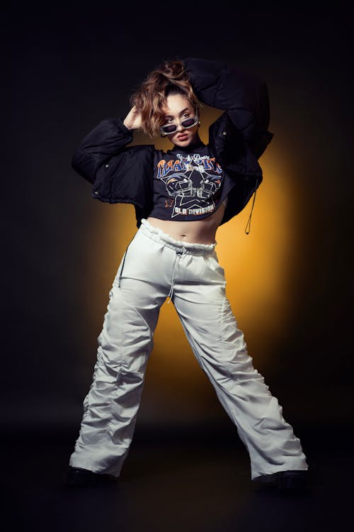 Model in a Black Jacket over a Printed T-shirt and White Pants