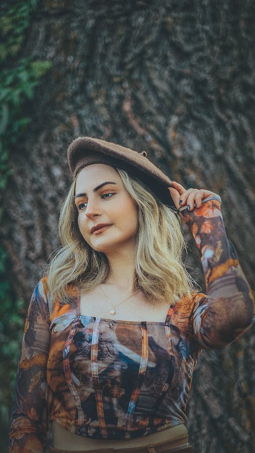 A beautiful blonde woman in a hat and top