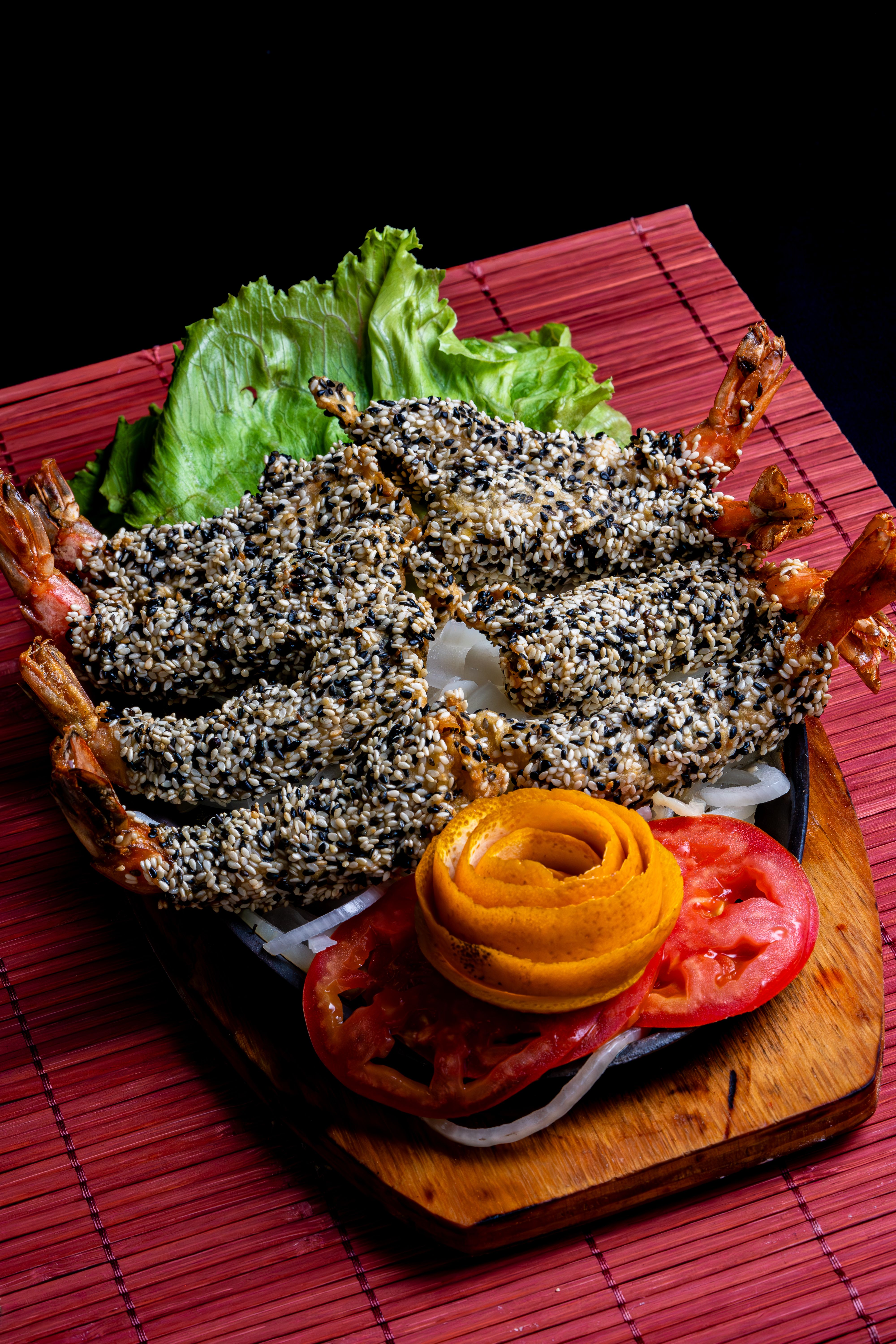 Delicious sesame-crusted shrimp served with fresh garnishes and a vibrant presentation.