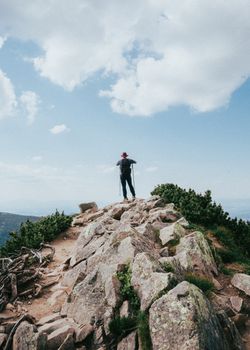 Man hiking on rocky mountain trail in Zakopane, enjoying outdoor adventure and stunning summer views. 20227625