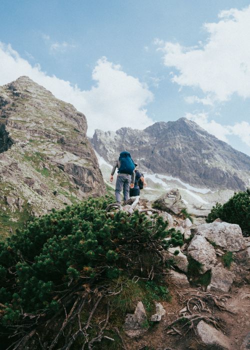 Free Two hikers trekking through the scenic Tatra Mountains on a summer day. Stock Photo