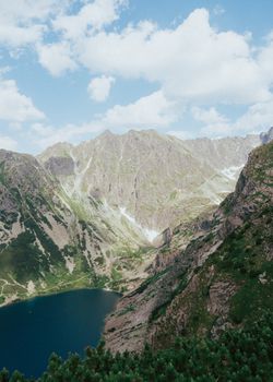 Breathtaking view of Czarny Staw Gąsienicowy surrounded by the majestic Tatra Mountains in Poland.