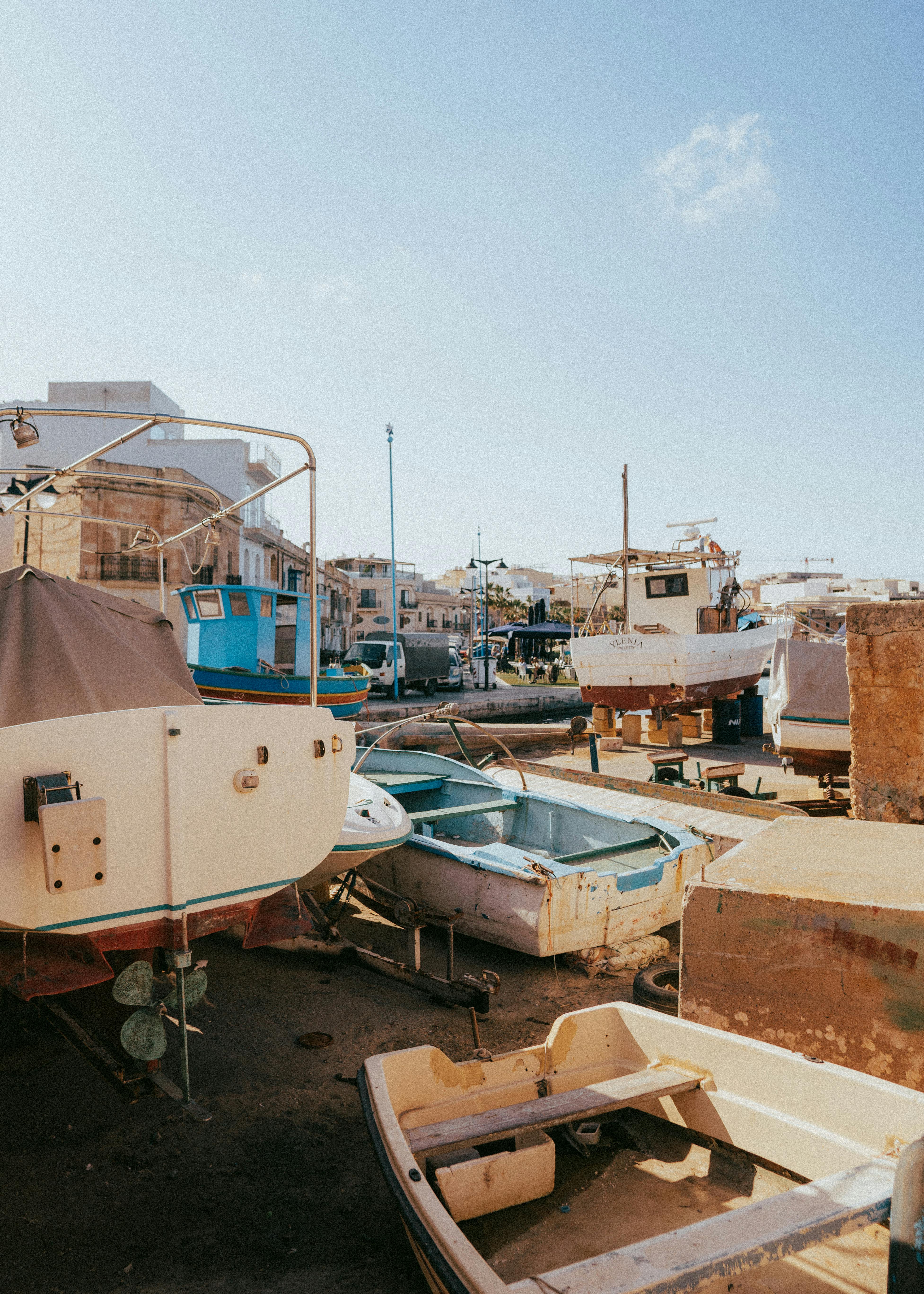 Idyllic scene of boats in Marsaxlokk harbor, Malta, capturing traditional Mediterranean charm.