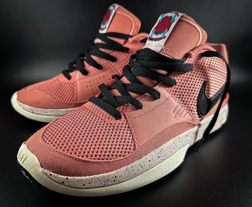 Free Close-up of fashionable pink sneakers with black laces on a black background. Stock Photo