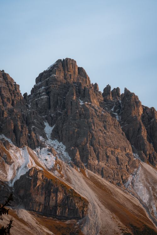 Free Captivating view of rugged mountain peaks bathed in soft sunrise light. Stock Photo
