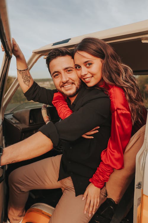 Smiling Couple Hugging in Car Door