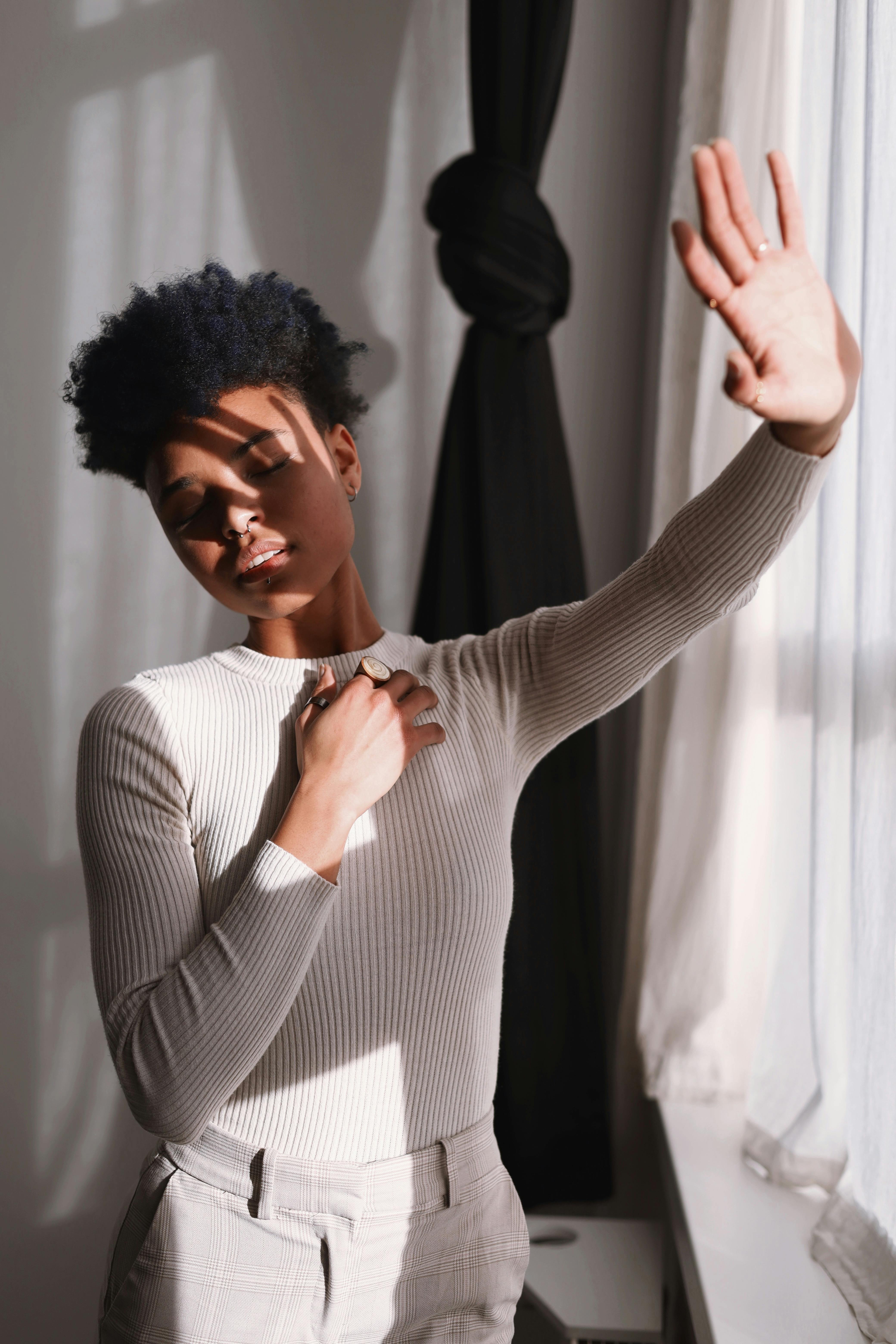 Model enjoying sunlight indoors, creating a fashion statement in Berlin