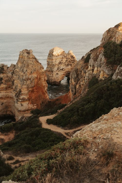 Free Explore dramatic rock formations along a stunning, rugged coastline with ocean views. Stock Photo