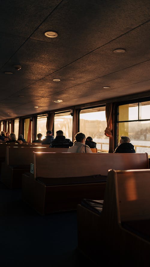 People sitting in a boat with windows