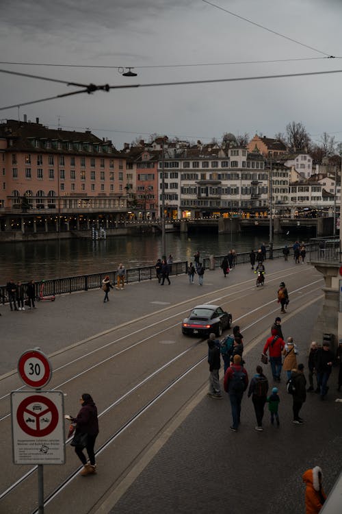 A city street with people walking and cars driving