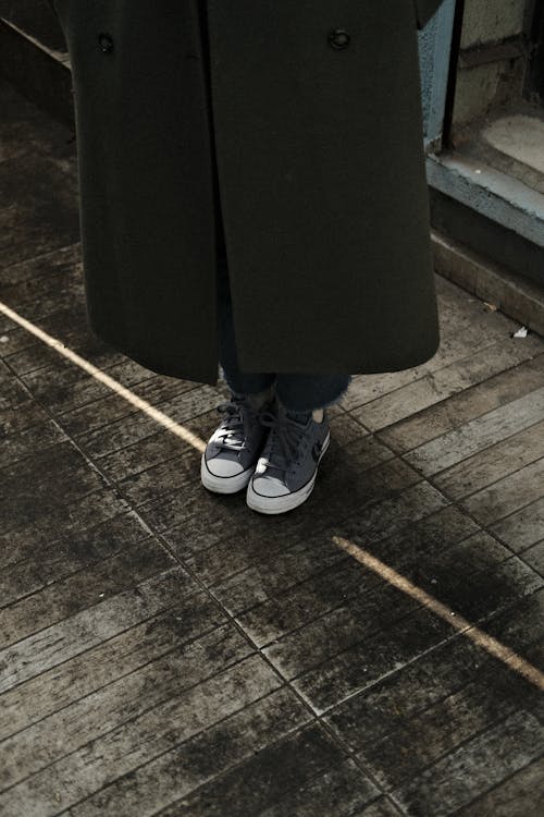 Person in Coat and Sneakers