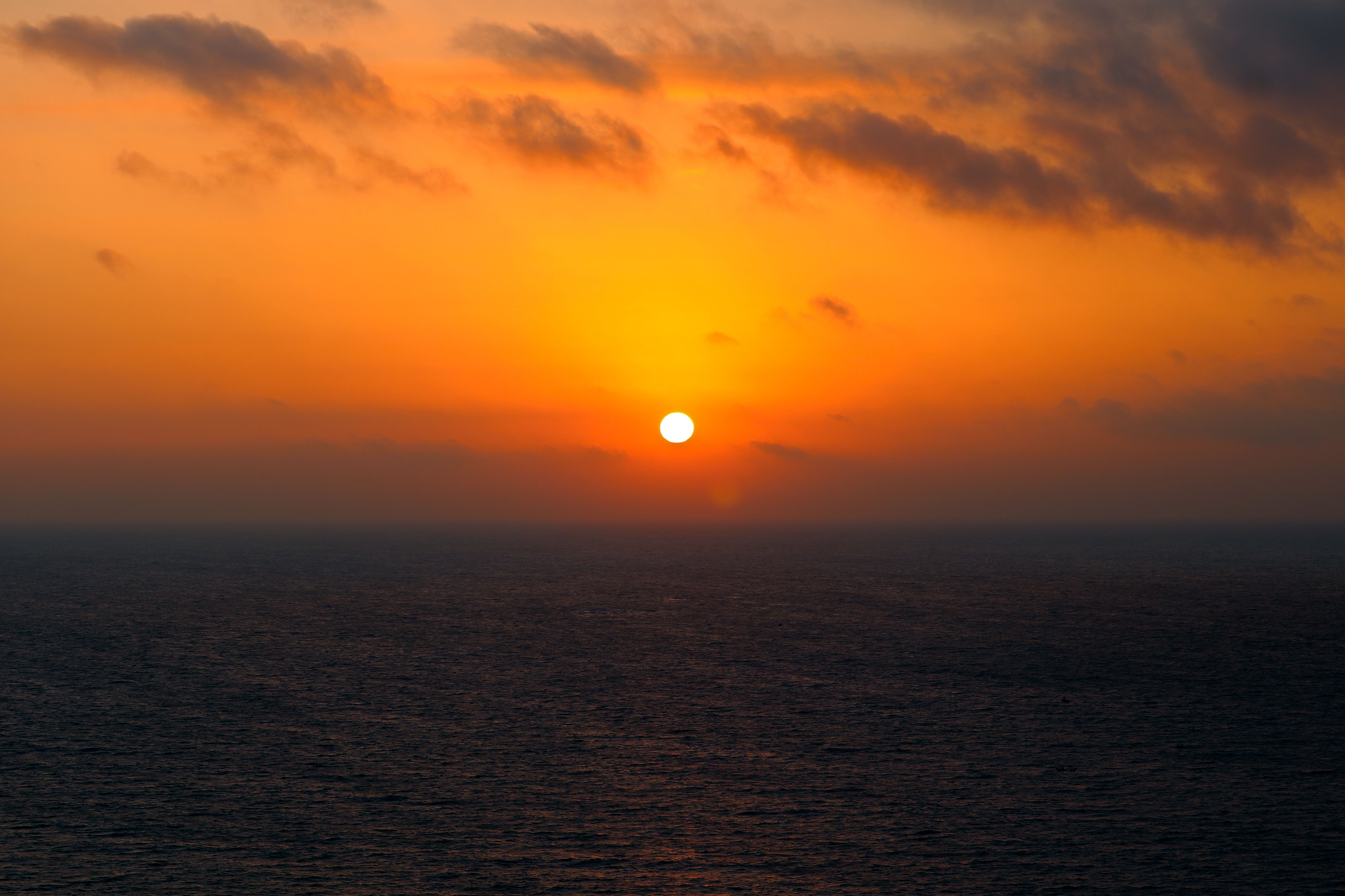 Sun on Yellow Sky over Calm Ocean at Sunset · Free Stock Photo