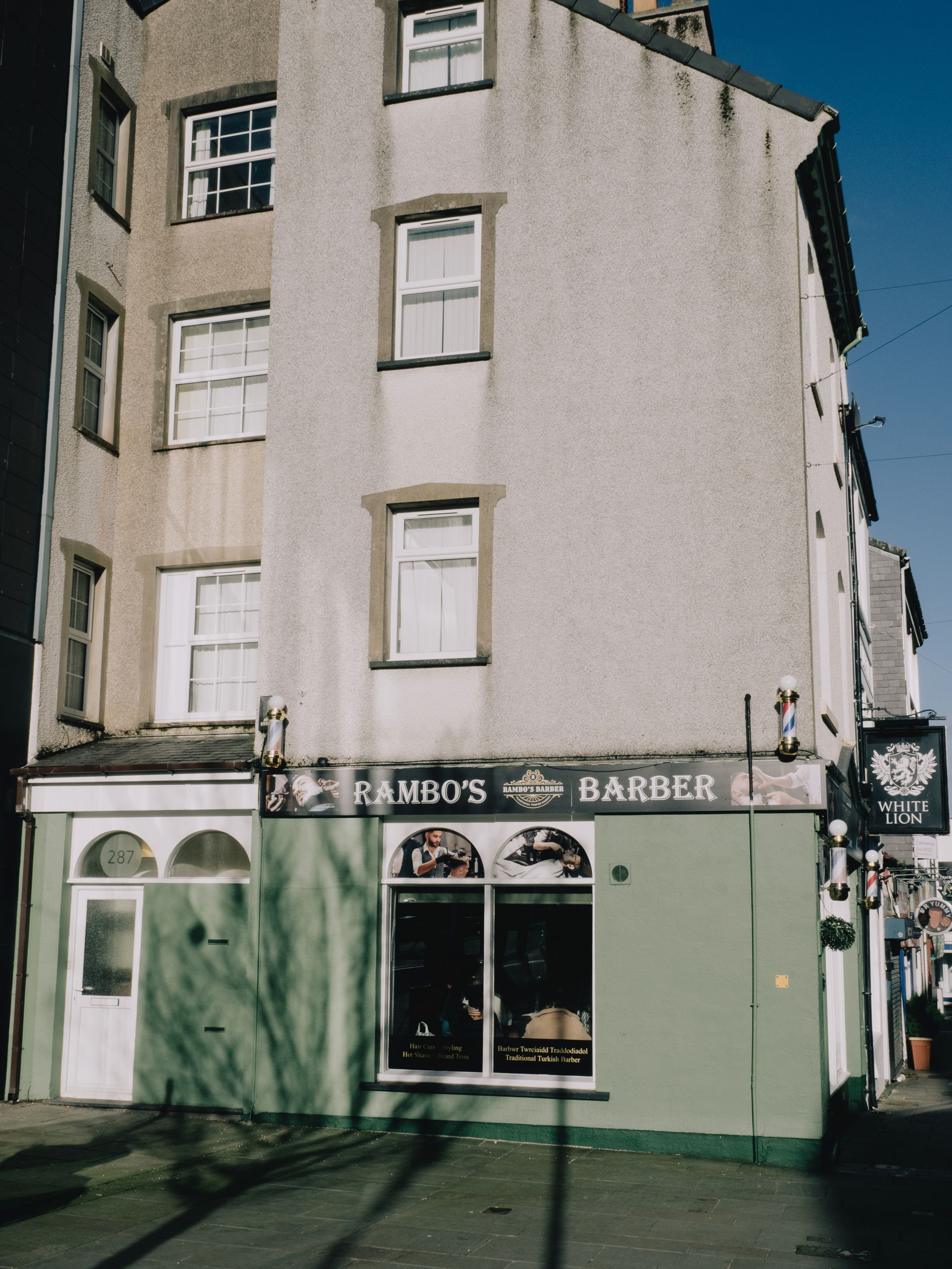 A traditional barber shop on a street corner in Bangor, Wales