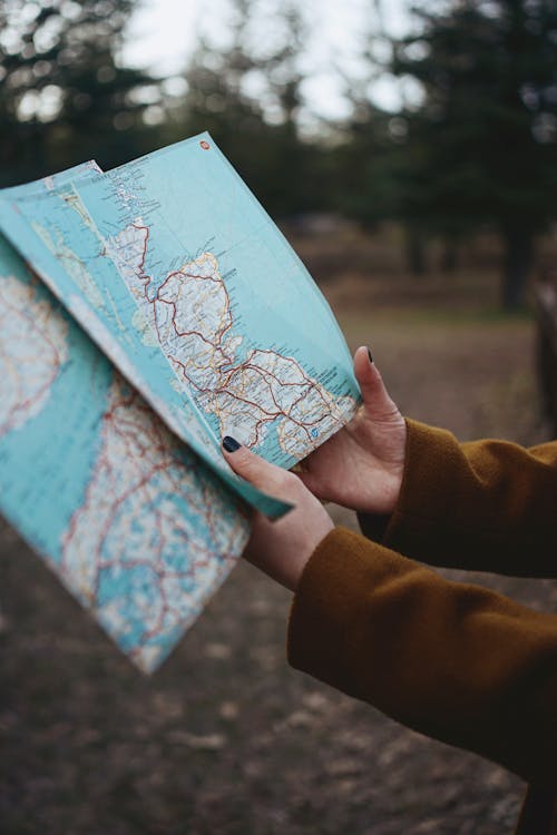 A person holding a map in their hands