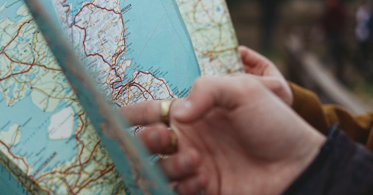 A person holding a map in their hand · Free Stock Photo