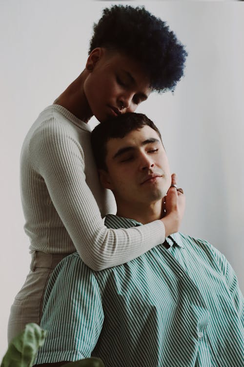 Woman Hugging Man in Green Shirt