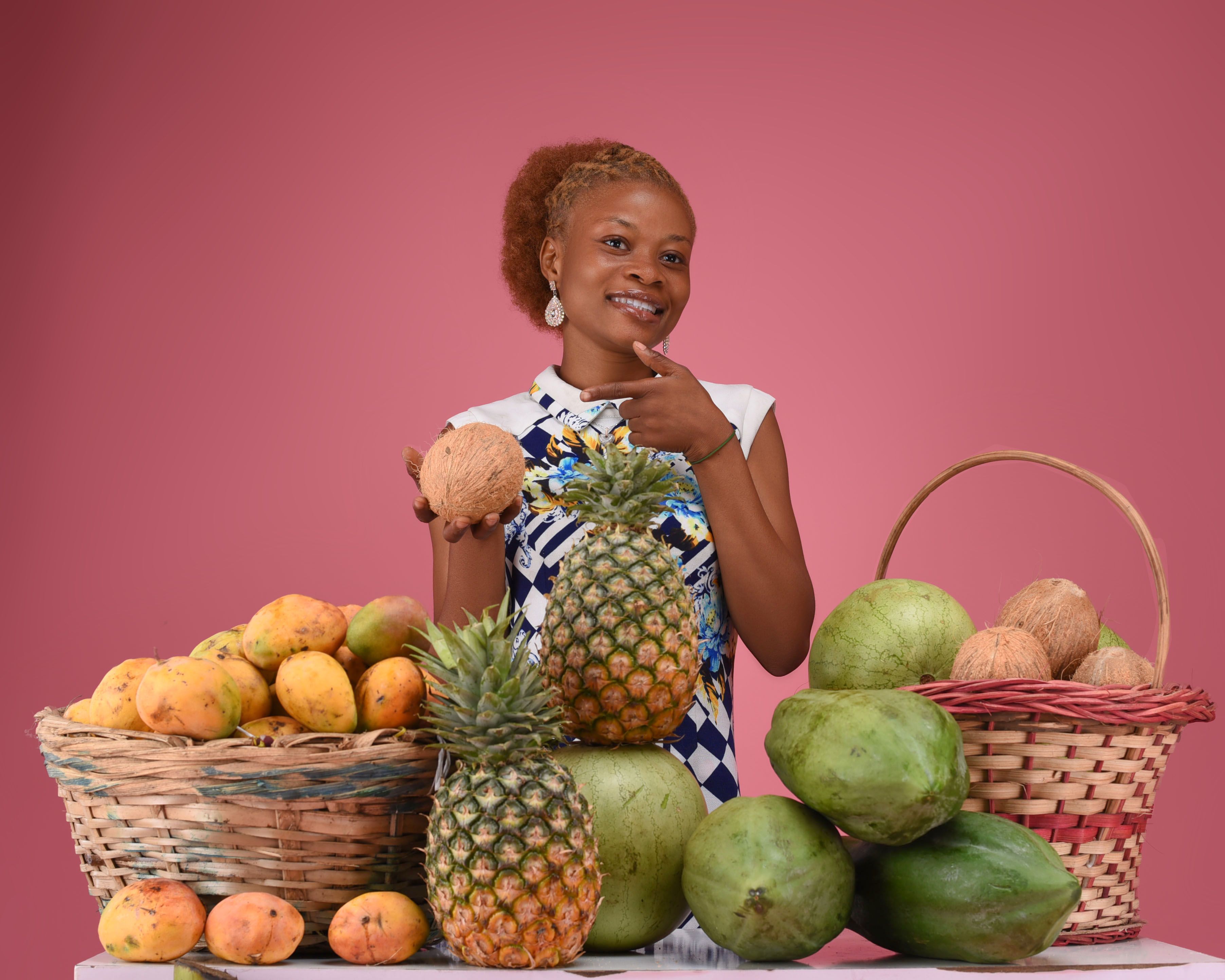 A woman holding a basket of fruits and vegetables · Free Stock Photo