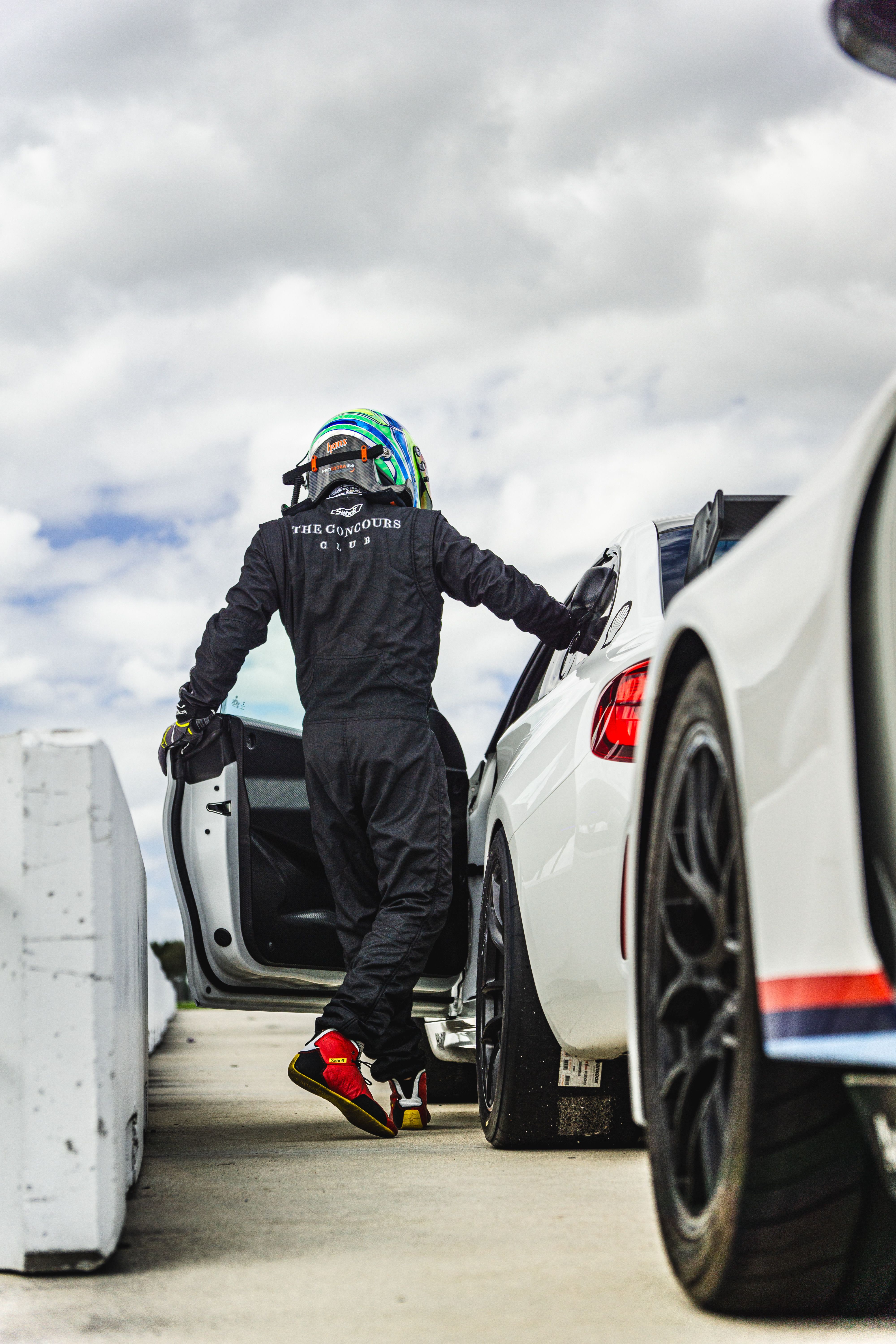 Racing Driver Standing by Car Door · Free Stock Photo