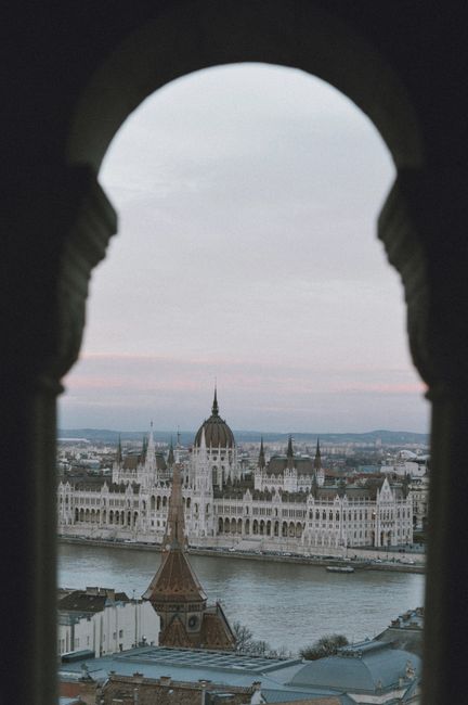 A view of the Hungarian Parliament across the Danube River at dusk.
