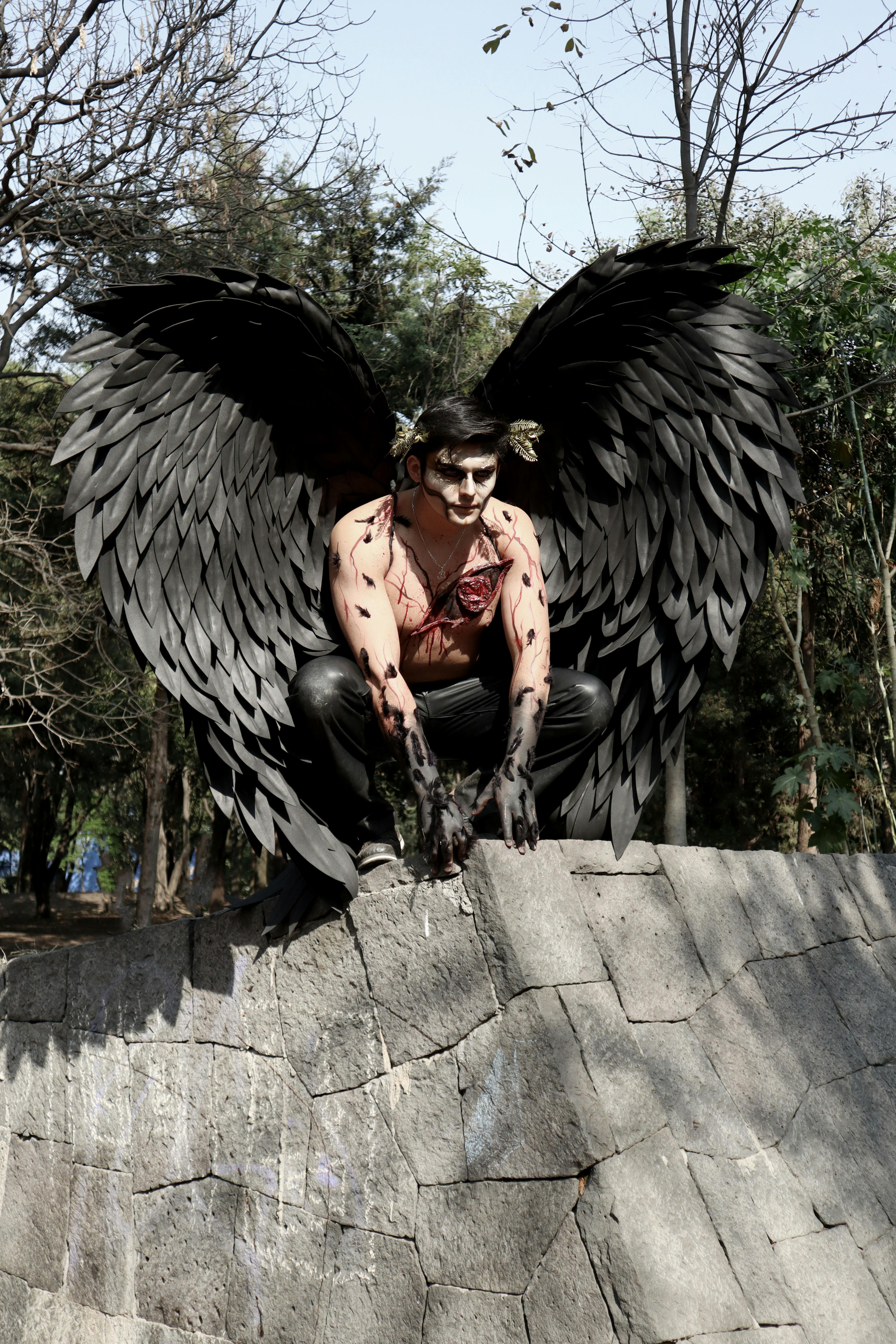 Evil Angel Sits on Rooftop · Free Stock Photo