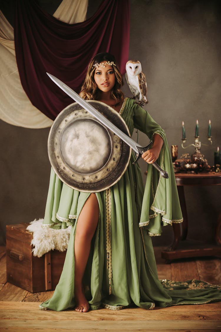 Model In Dress Standing With Shield And Sword