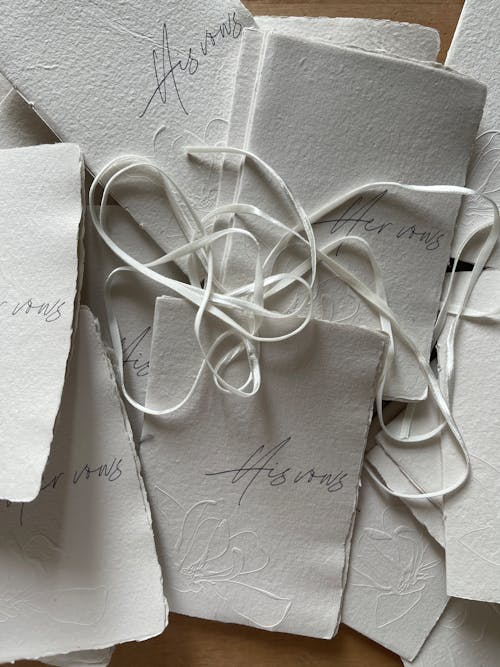 A bunch of white envelopes with string tied to them