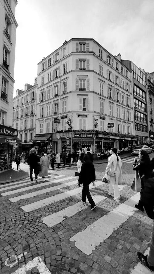 Black and white photo of people crossing the street