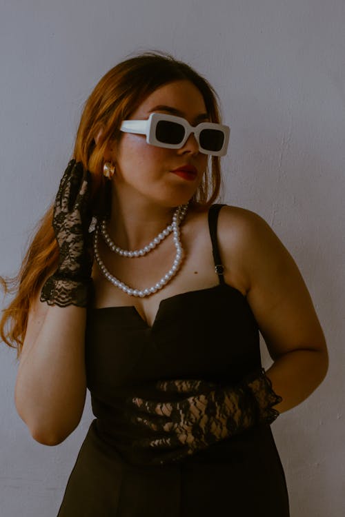 A woman in black and white is wearing sunglasses
