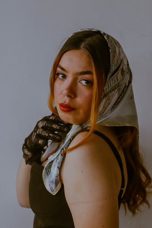 A woman with long hair and a scarf on her head