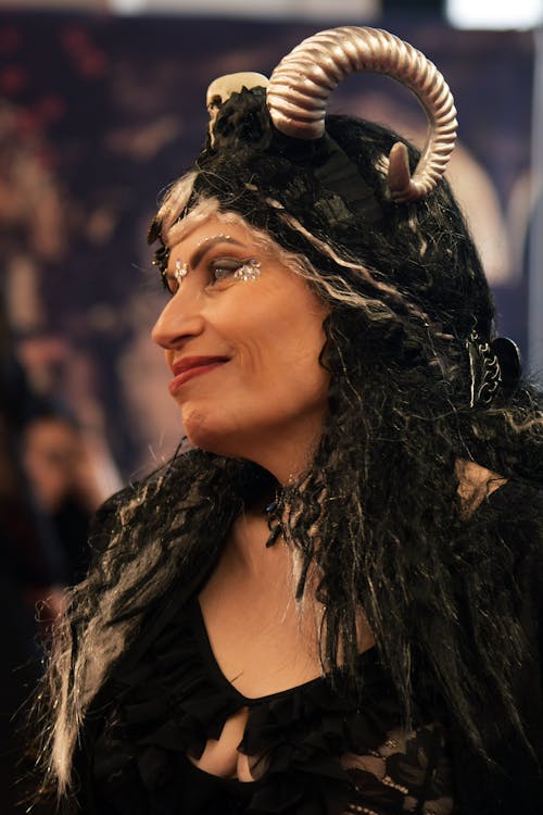 A woman with horns and a black dress