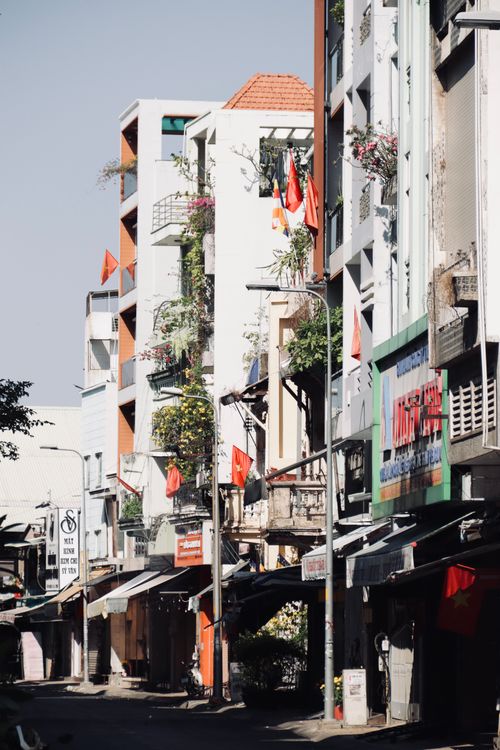 Free A sunlit street in Hanoi, showcasing vibrant urban architecture and daily life. Stock Photo