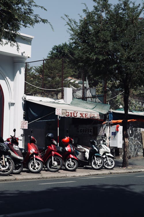 Motor Scooters Parked on Sidewalk in Town in Vietnam