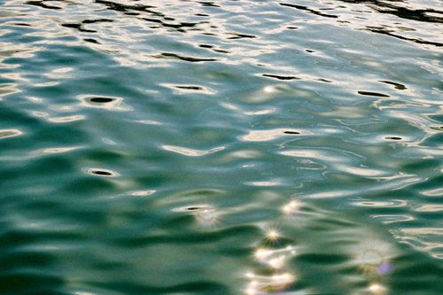 Free Tranquil image of water with rippling surface reflecting sunlight, evoking calmness. Stock Photo