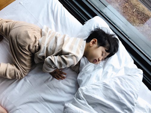 Free Child Sleeping on Bed  Stock Photo