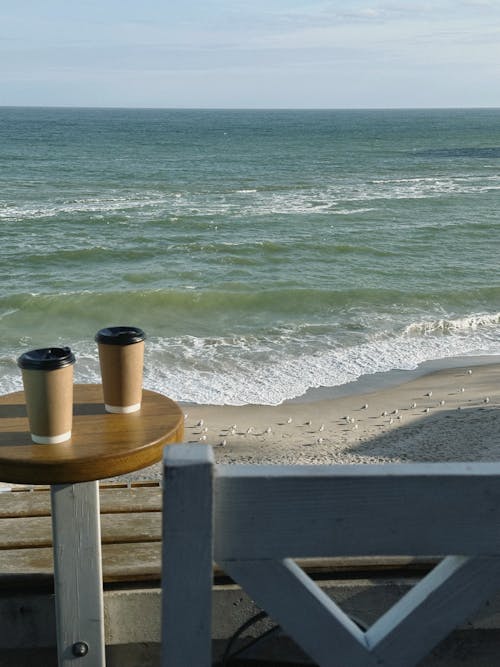 Disposable Cup on Table by Sea