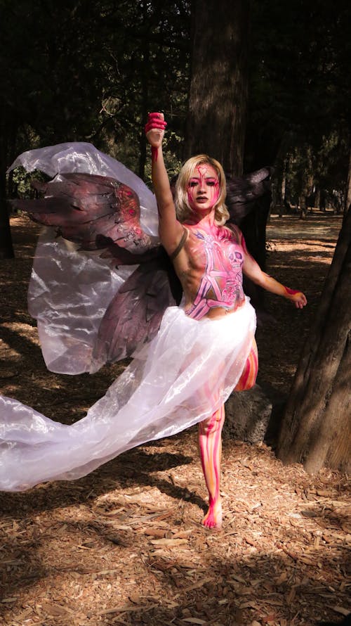 A woman dressed as a fairy with a bloody face