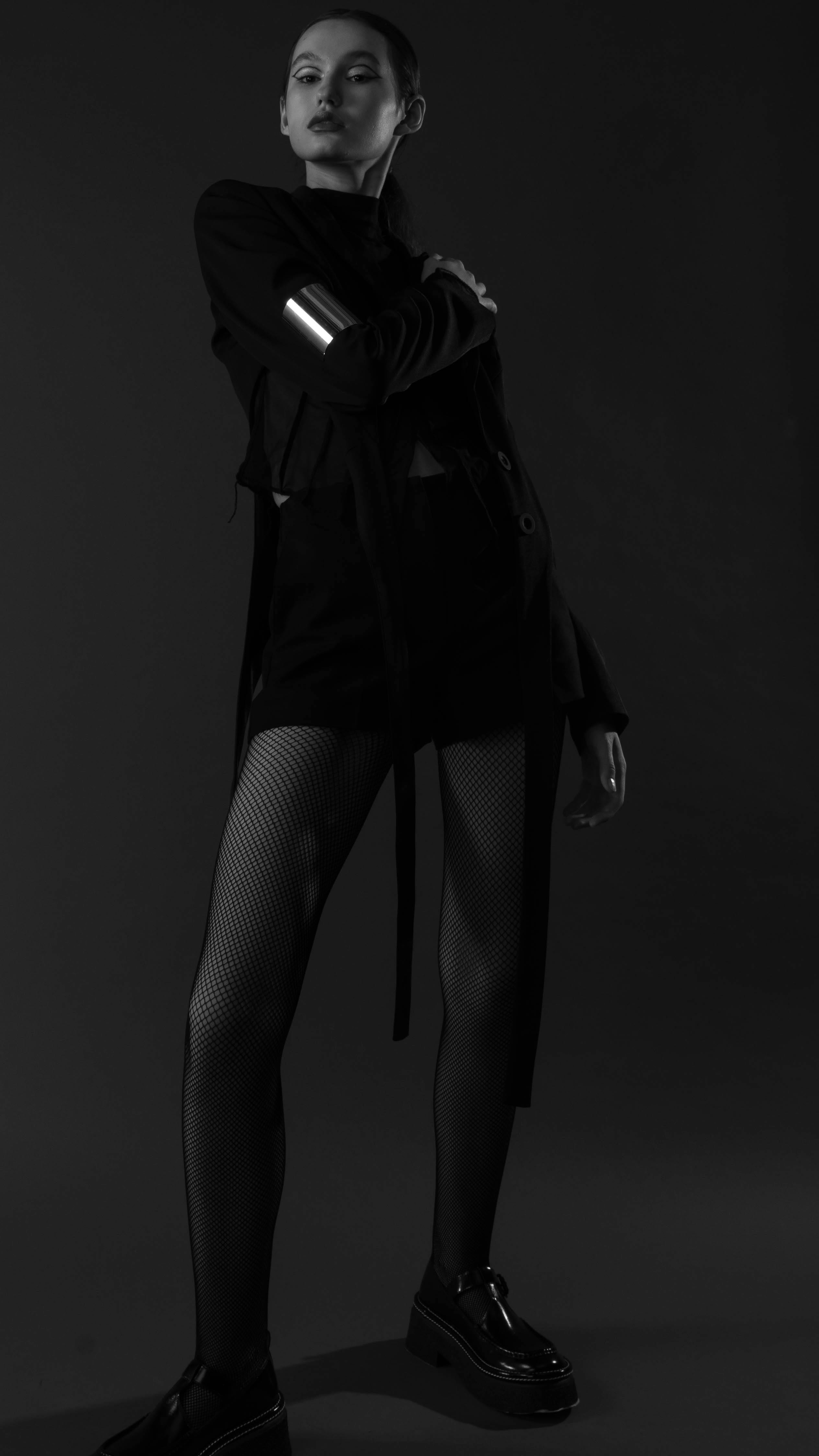 Free Stylish monochrome fashion portrait of a woman wearing a mini dress and stockings. Stock Photo