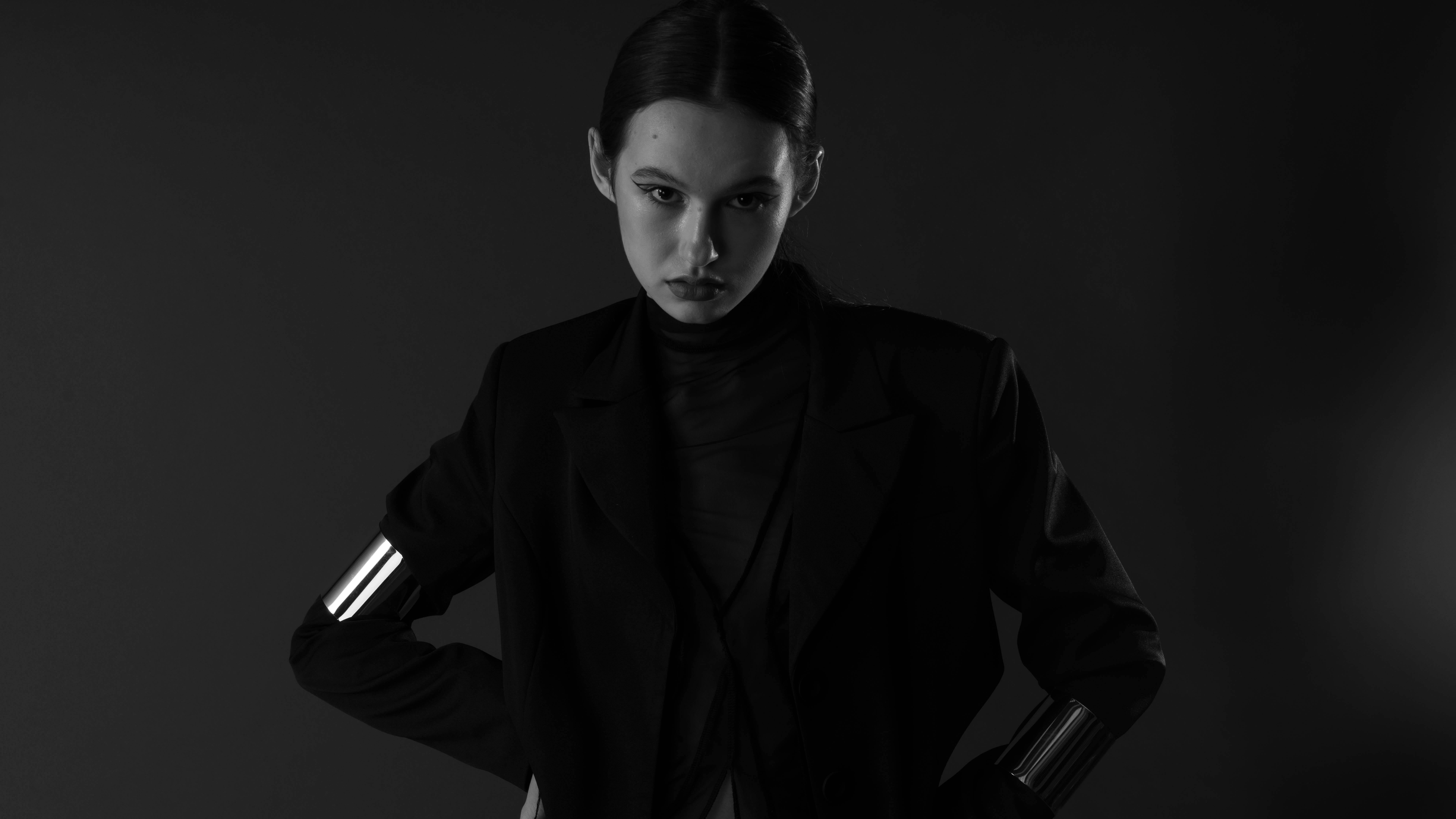 Free Striking black and white fashion portrait of a woman with an intense gaze, wearing a stylish ensemble. Stock Photo
