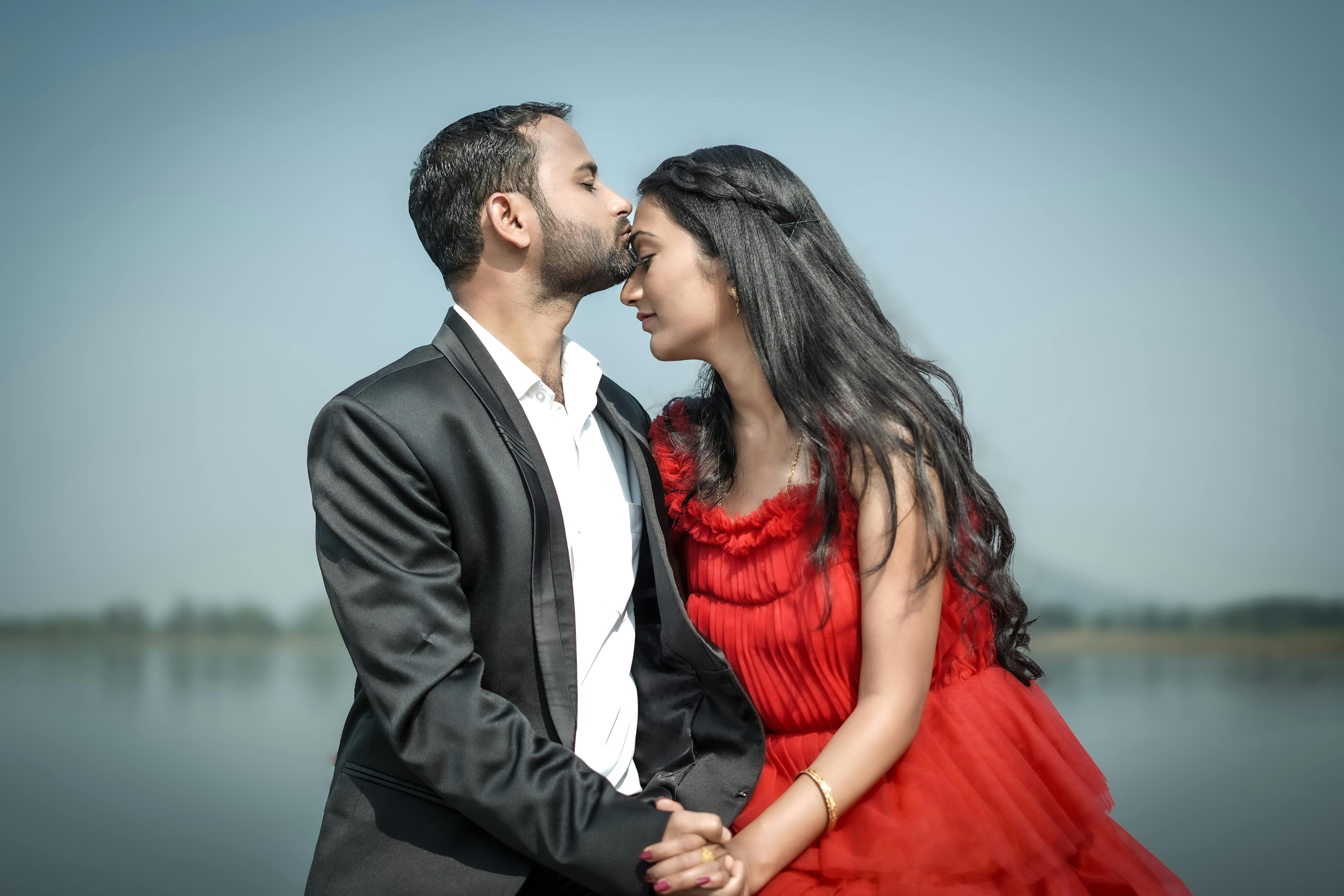 Man in Suit is Kissing Woman Foreheads · Free Stock Photo