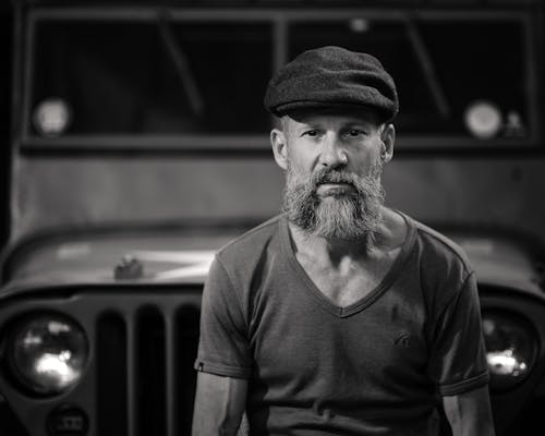 Bearded Man In Front of a Vehicle