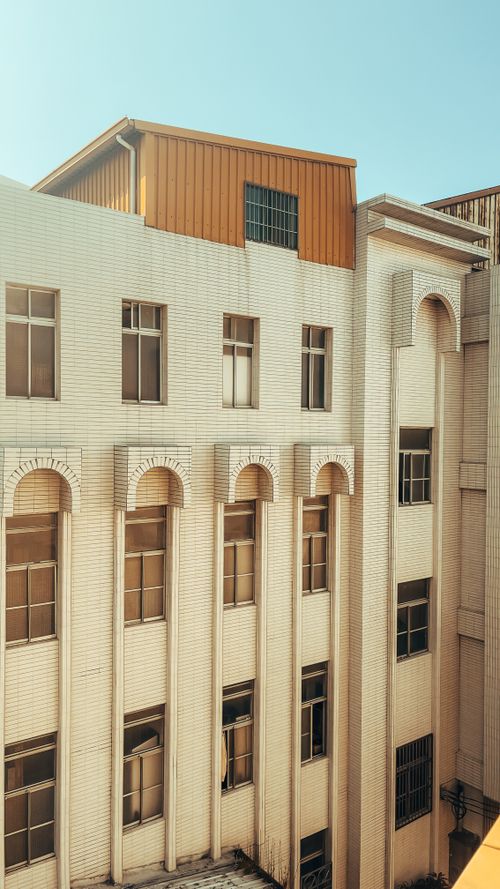 Free Bright urban building facade with classic design and modern materials in city setting. Stock Photo