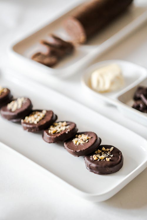 A plate of chocolate covered cookies and nuts