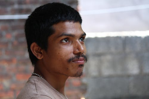 Photo of a Young Man with Mustache Looking Away 