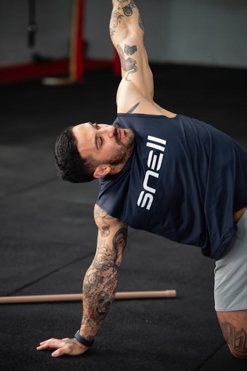 Free A man doing a push up in a gym Stock Photo
