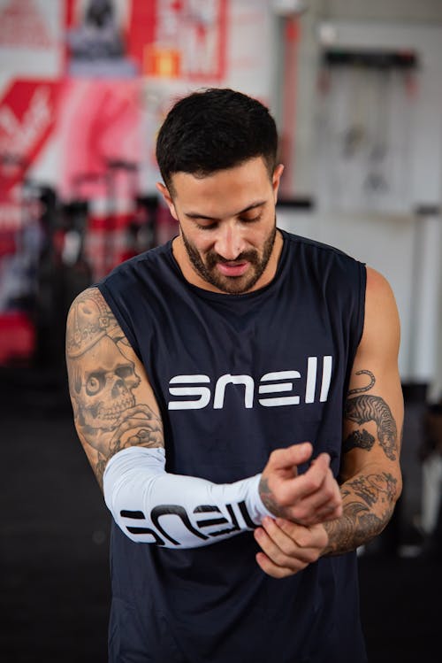 Free A man in a gym with a sleeve on his arm Stock Photo
