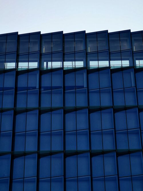 Free Elegant modern glass building facade in Las Condes, Santiago, showcasing sleek architecture. Stock Photo