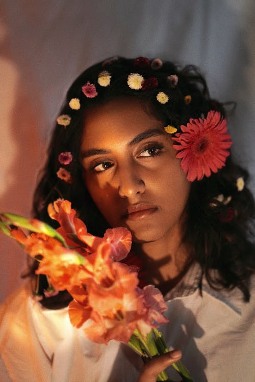 A woman with flowers in her hair and a flower crown