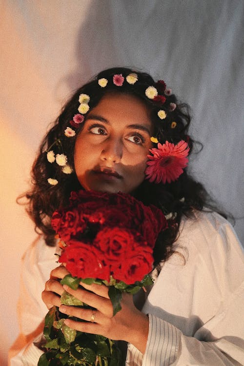 Young Woman with Flowers in Her Hair and a Bouquet of Roses