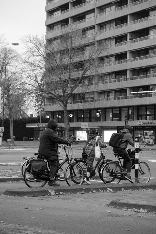 Free Black and white photo of cyclists riding through Eindhoven, Netherlands. Stock Photo